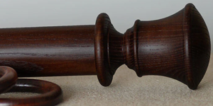 Mahogany curtain pole with Orton finial and matching ring.