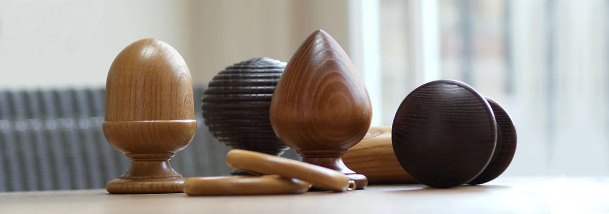 table top display of wood curtain pole finials and rings
